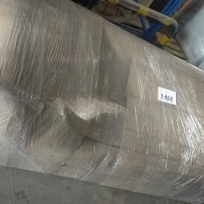 A sofa fully wrapped and secured before loading