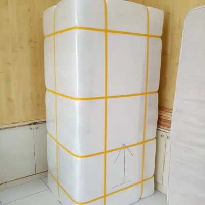 A wardrobe shrink-wrapped and strapped for transport