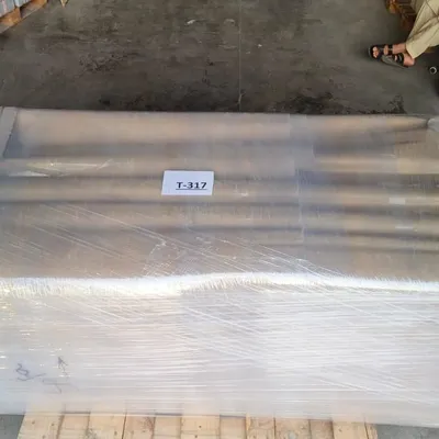 Our team wrapping an item with stretch film during packing